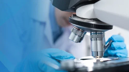 Researcher with microscope